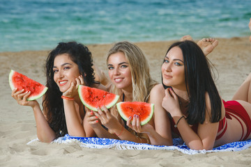 Young attractive cheerful women on the beach having fun