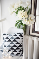 Bouquet of spring flowers in room interior, white tulips and daf