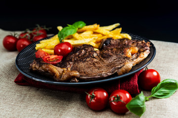 juicy steak beef meat with tomato and french fries