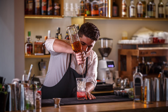 Barman pouring drink