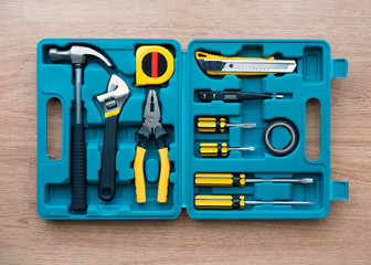 New square tool box on wooden texture background. Top view