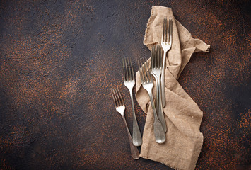 Vintage forks on rusty background
