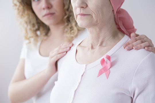 Senior woman with pink ribbon