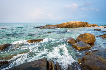 Fototapeta na wymiar Sea rocks on the beach in morning