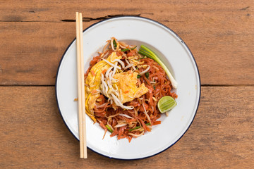Traditional Thai fried noodle on wooden texture and background