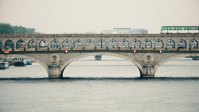 Paris. Metro train and traffic at the Bercy Bridge on the River Seine
