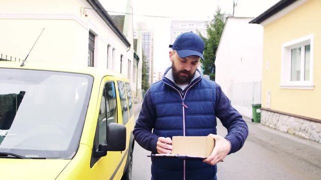 Delivery man delivering parcel box to recipient.