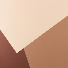 Color papers geometry composition background with pink, beige and brown tones.