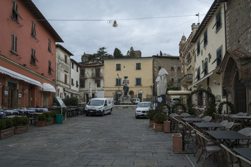 MONTECATINI ALTO, ITALY - FEBRUARY 2018; Medieval buildings on central city square surrounded with street cafe and small shops