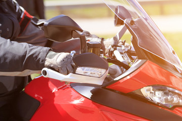 Biker hand rests on the steering wheel motorcycle close-up
