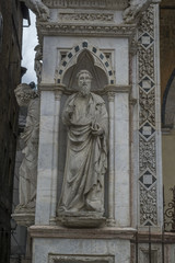 Statue on the column of Torre Del Mangia on Central city square called Piazza Del Campo in Siena, Italy
