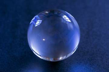 Glass ball of transparent ball on a dark background