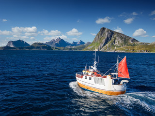 Fishing boat in Norway fjord - sea in lofoten amazing nature.