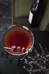 red cocktail with berries of cherry and whiskey
