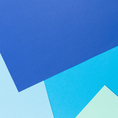 Color papers geometry flat composition background with blue tones