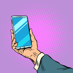 Smartphone in male hand selfie