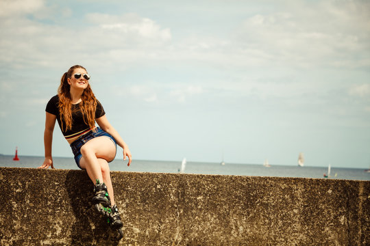 Happy young woman wearing roller skates