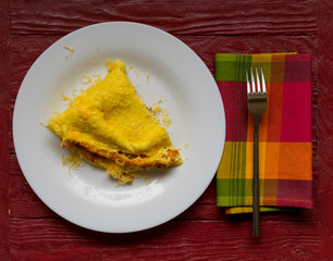 Omelette with grated cheese on a plate.
