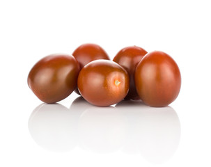 Five black red grape cherry tomatoes isolated on white background.