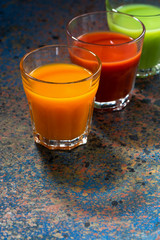 vegetable juices in glass beakers, vertical