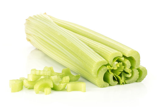 One fresh green celery with chopped pieces stack isolated on white background.