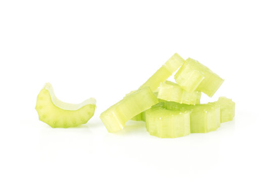 Fresh green celery chopped sliced pieces heap isolated on white background.