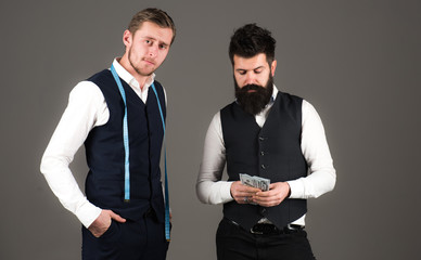 Tailor and businessman holds cash, money, payment.