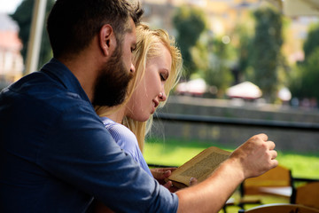 Young couple enjoys the outdoors with a book