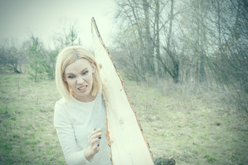 Naklejka premium The concept of hard work of a woman. A woman is pulling a log. Toned.