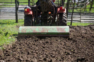 The tractor trash the earth and prepares it for spring sowing.