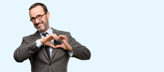 Teacher man using glasses happy showing love with hands in heart shape expressing healthy and...