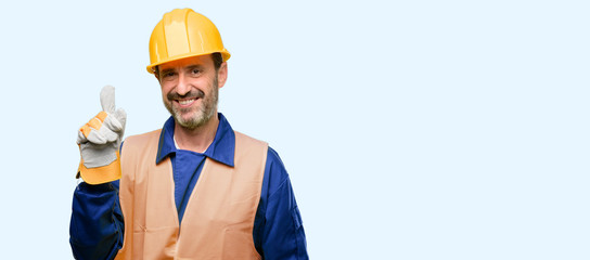Senior engineer man, construction worker pointing away side with finger isolated over blue...