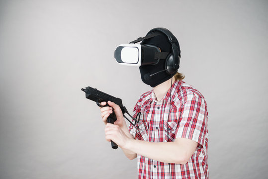 Gamer man wearing VR holding gun