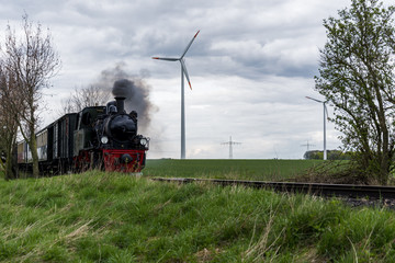 Obraz premium old steam train in a modern environment