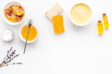 Homemade cosmetics with honey. Handmade soap, spa salt, cream on white background top view copy space