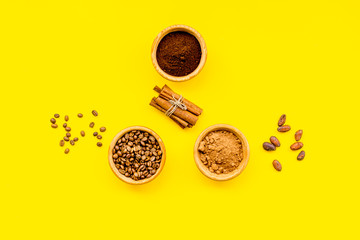 Ingredients for bakery and desserts. Cinnamon, cocoa, coffee, sugar, spices on yellow background top view