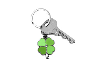 charm in the form of a clover with a key, on a white background close up