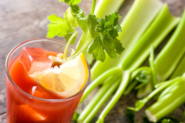 Bloody Mary cocktail in glass on wooden table.Copyspace