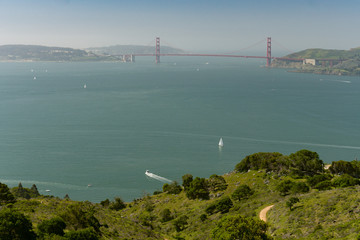 Fototapeta premium Wide sweeping view of the Golden Gate Bridge, city of San Francisco, and surrounding bay seen from up high on Angel Island