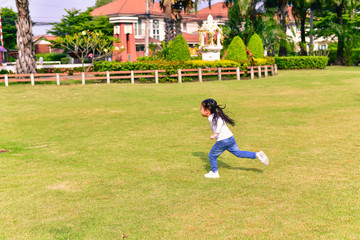 The girl is playing in the park.