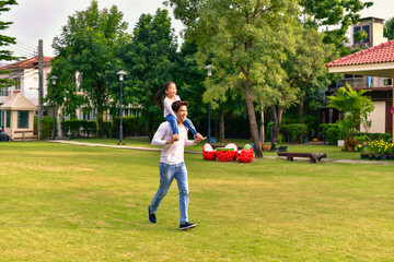 Parents and daughters go for a walk in the park.