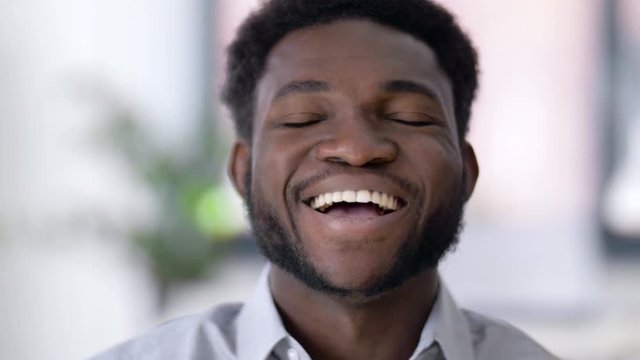 business and people concept - portrait of laughing african american man