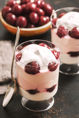 Dessert creamy cottage cheese with cherries in glasses.