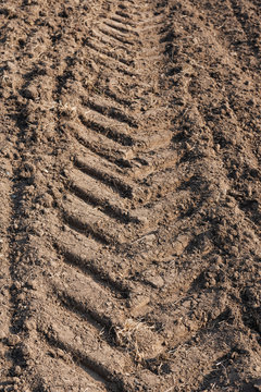 detail view of tracks of tractor tires on a field