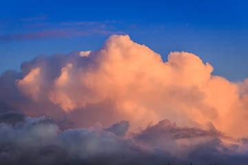 Puffy orange clouds in a bright blue sky