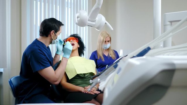 Dentist and his assitant working in private practice.