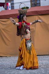 Woman dancing oriental dance on the street