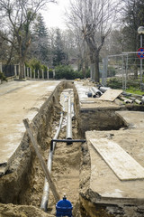 trench with pipes, road with trench, construction site.