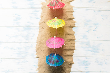 Summer concept. Beach umbrellas on a wooden blue background