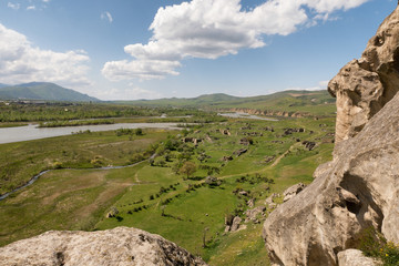 Fototapeta na wymiar  Cave town Uplistsikhe Georgia. Scenic view from above on valley with fragments of ruins.